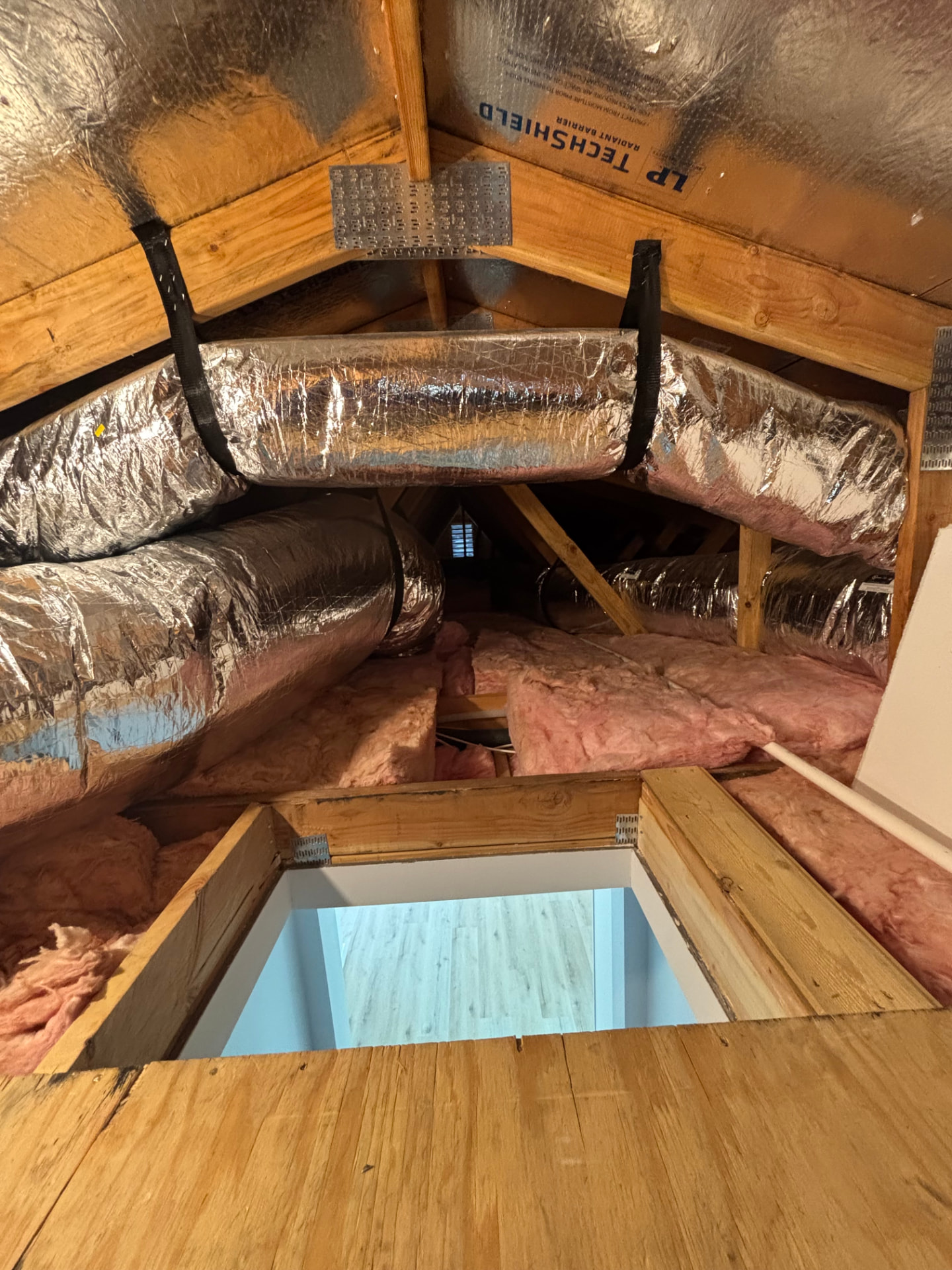 Insulated attic ductwork feeding a home HVAC system