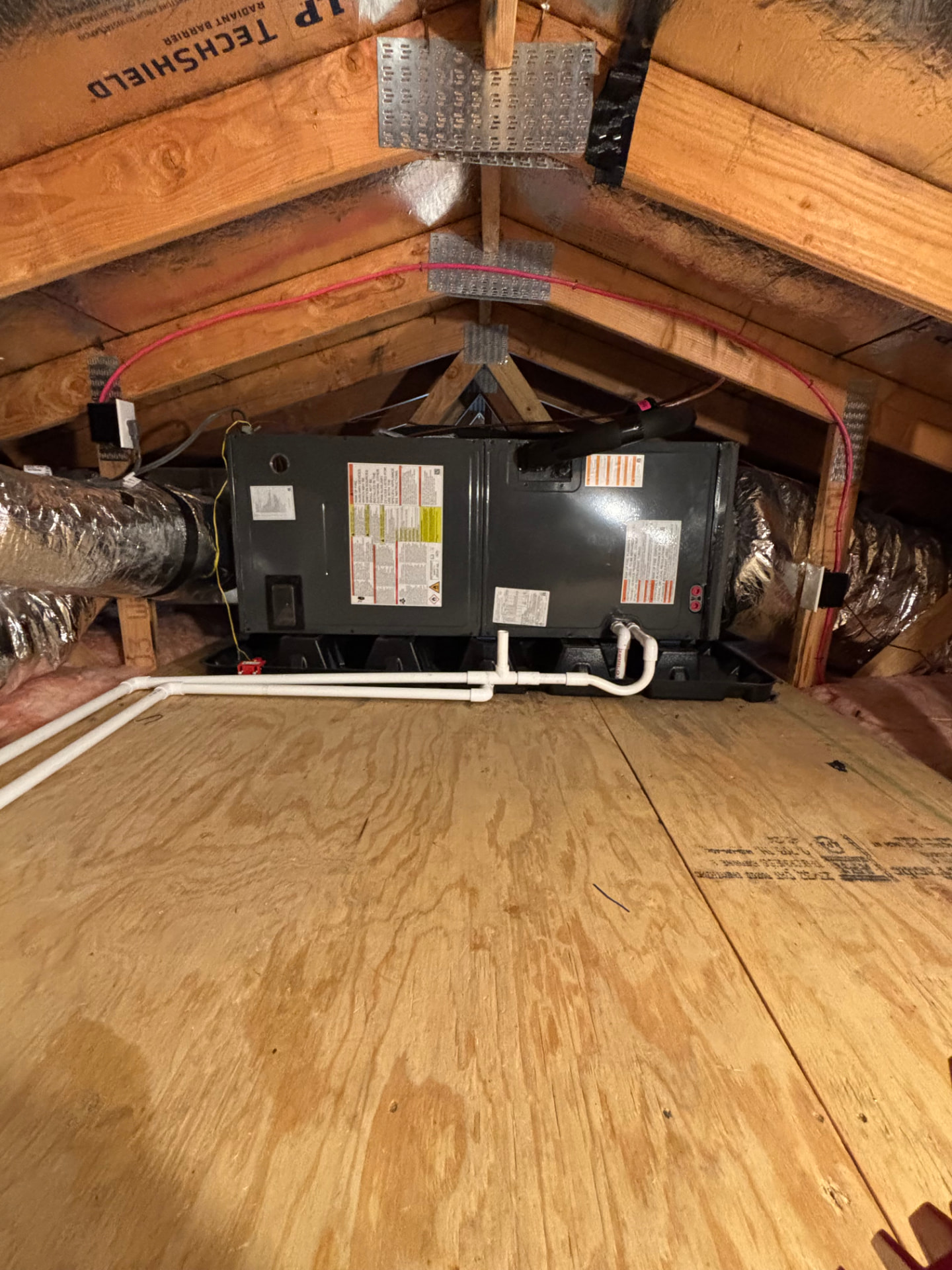 Attic-mounted HVAC system connected to insulated ductwork
