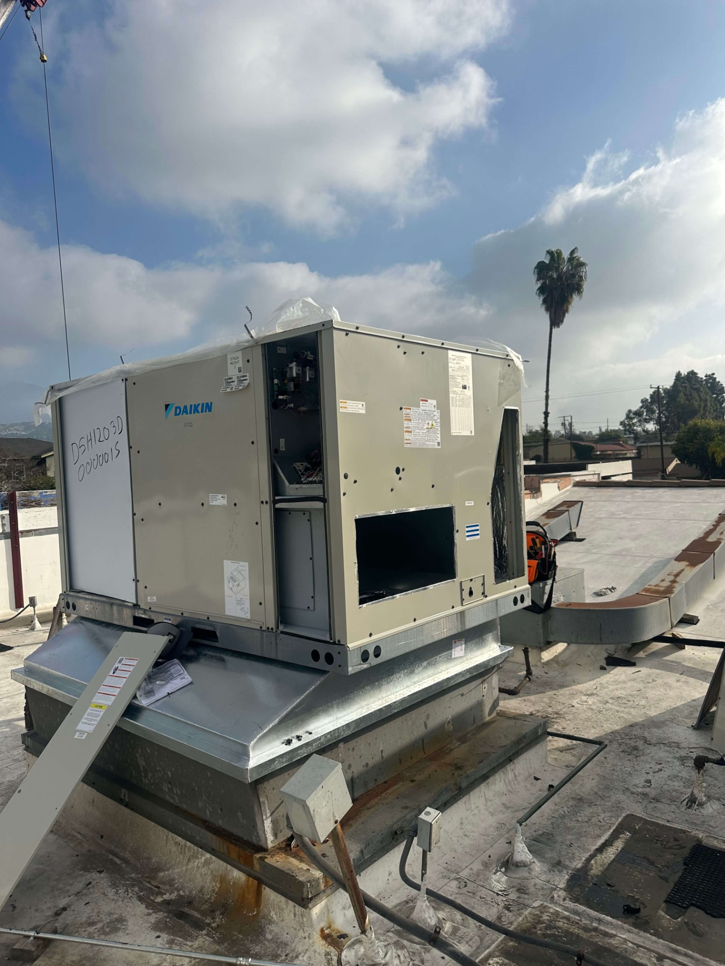 Packaged HVAC system being set in place during a full system installation